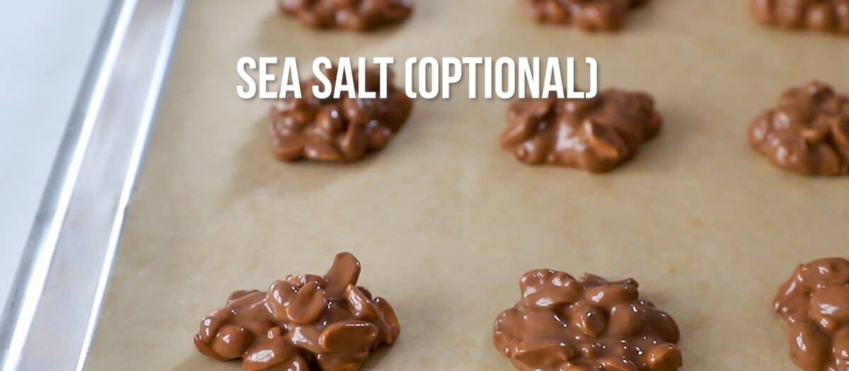 Chocolate clusters on a parchment lined baking sheet. 