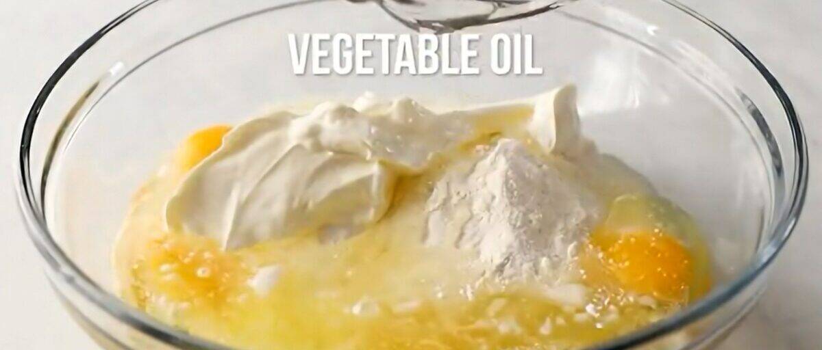 Combining the ingredients to make the cake batter in a glass bowl. 