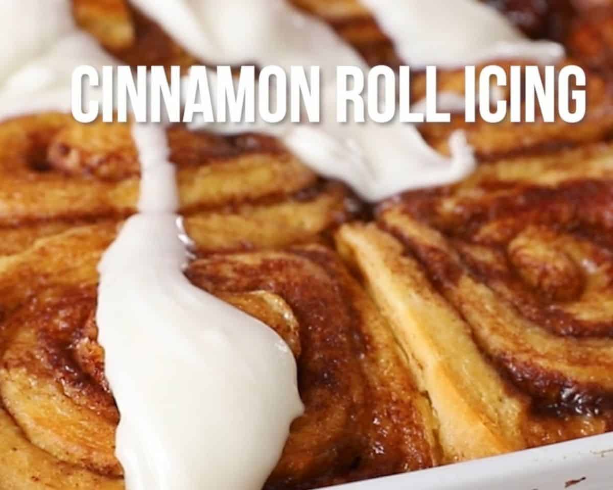 Pouring icing over the baked cinnamon roll. 