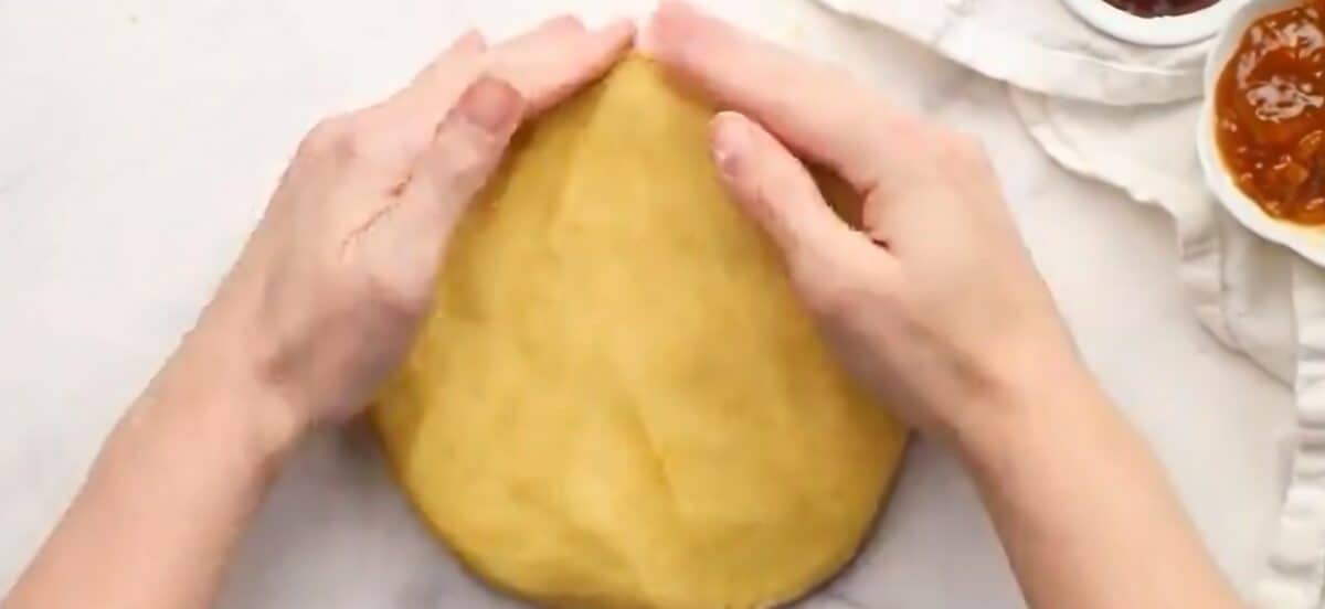 Flattening the dough into a disk.