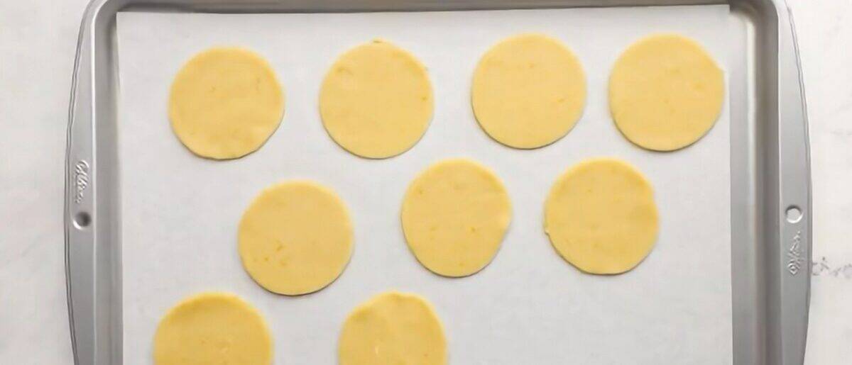 Dough disks on a lined cookie sheet. 