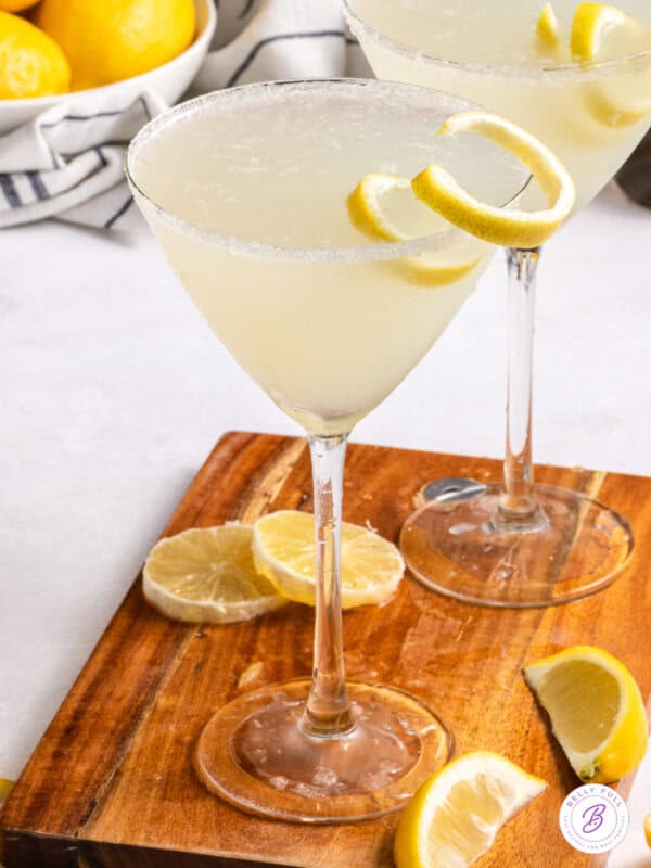 Two lemon drop martinis on a cutting board