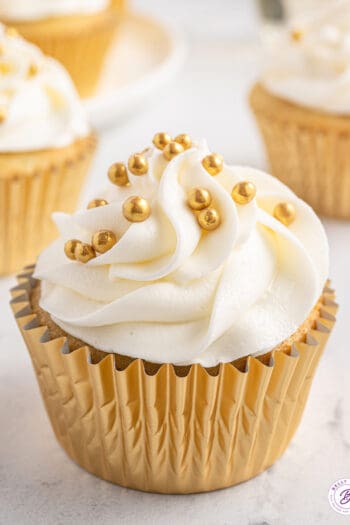 A prosecco cupcake in a gold cupcake wrapper