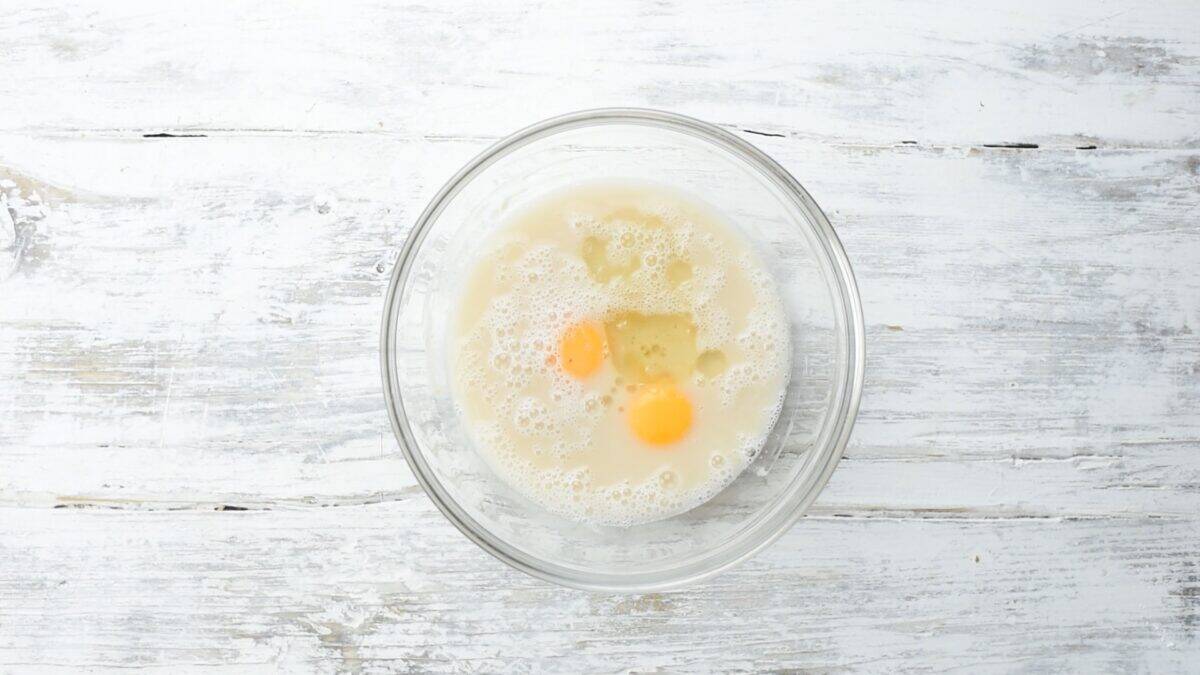 Adding wet ingredients to the yeast mixture.