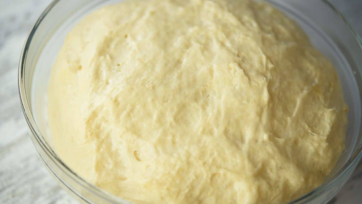 Risen dough in a glass bowl.