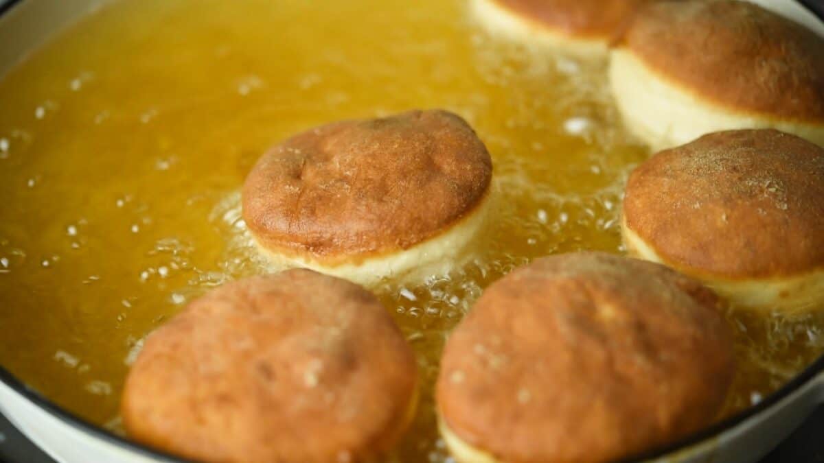 Deep frying the donuts.