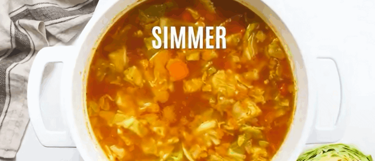 Simmering the tomatoes with the other cabbage soup ingredients.