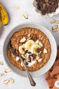 overhead chocolate-y steel cut oatmeal in bowl with bananas