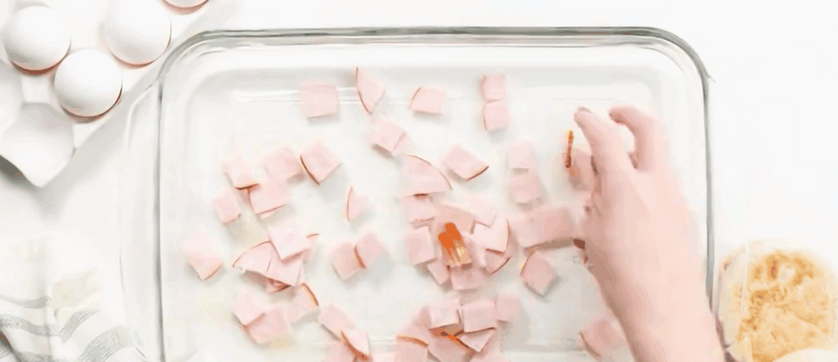 Layering bacon in the baking pan.