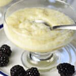 tapioca pudding with spoon in glass dessert cup