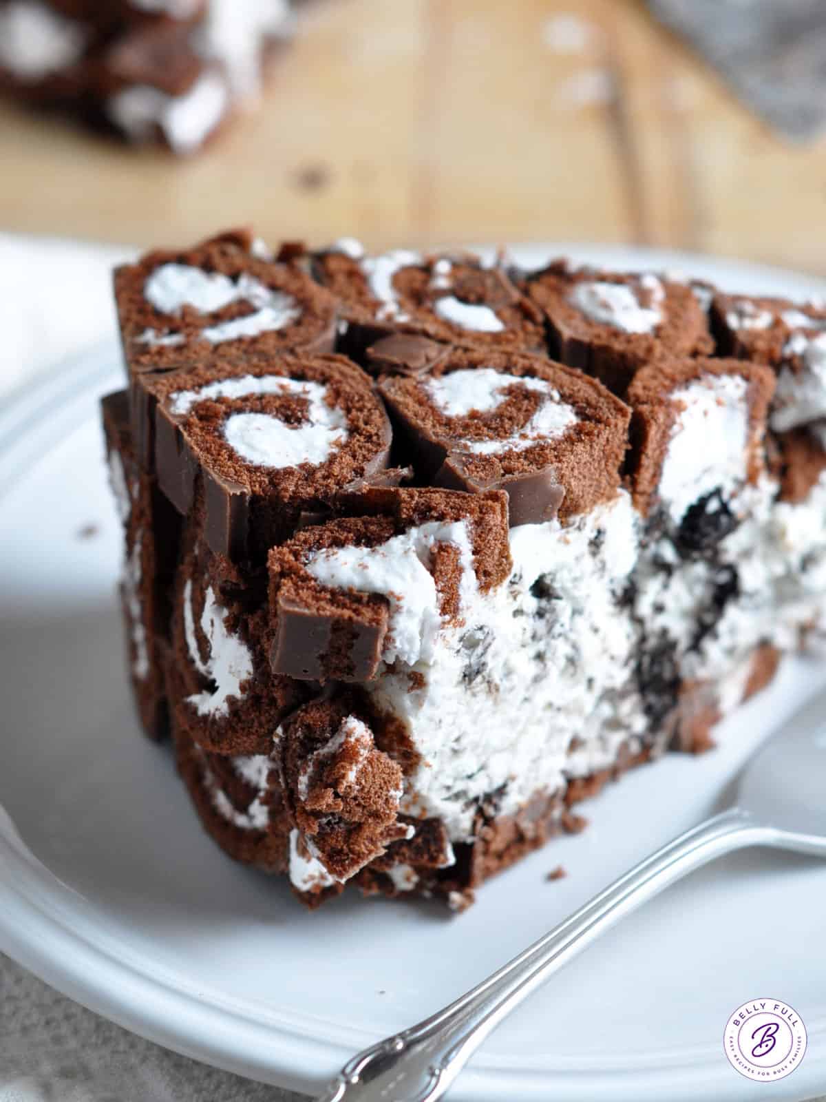 Close up slice of cookies and cream swiss roll cake