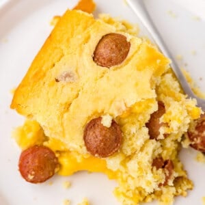 square piece of corn dog casserole on white plate