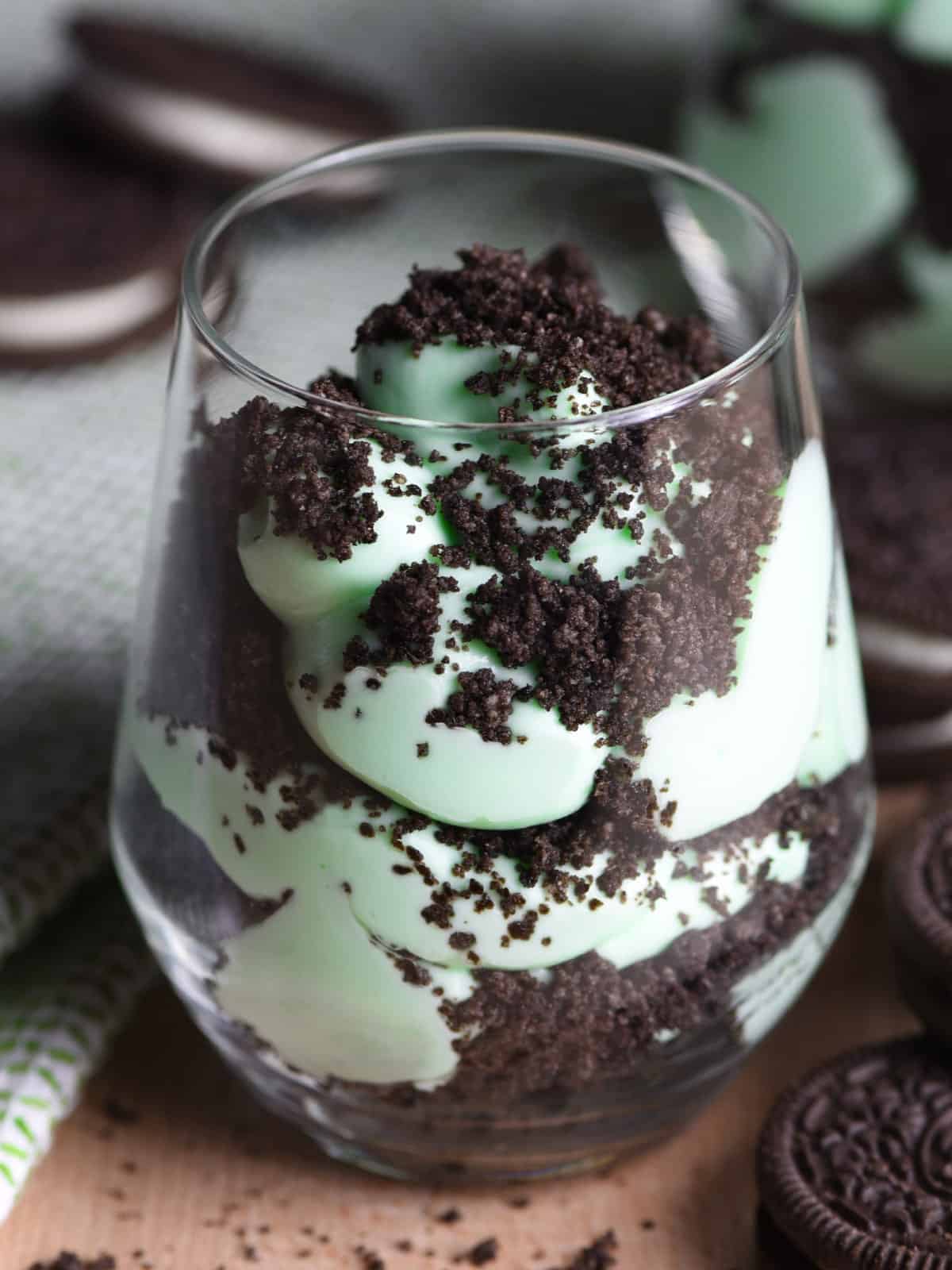 layered crushed mint oreo and whipped cream in glass