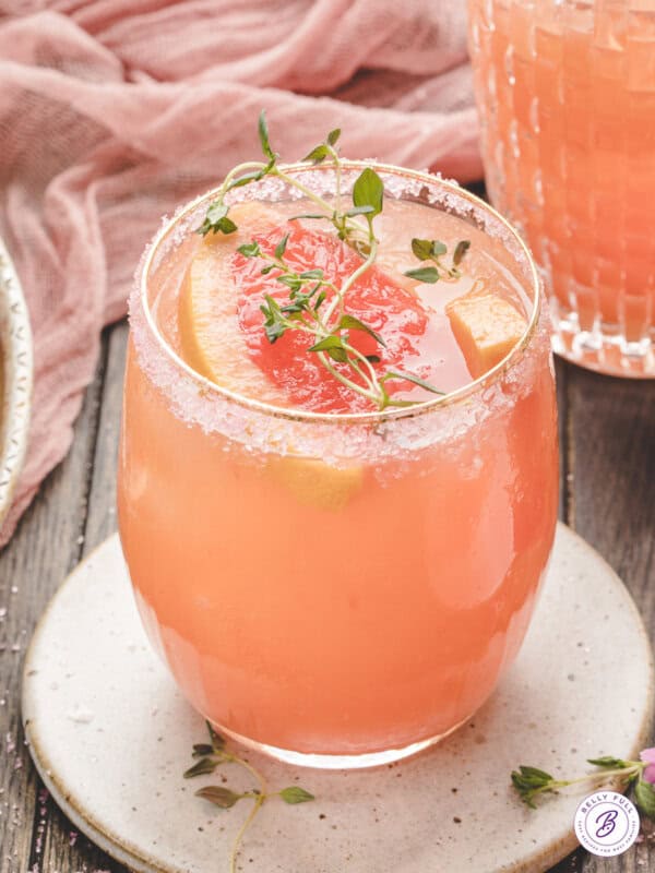 A salty dog cocktail on a silver coaster