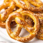 Short soft pretzels with salt on a plate