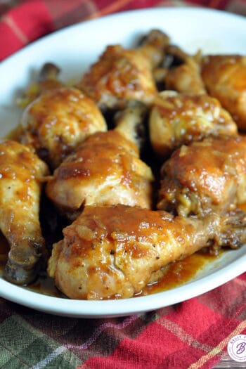 cooked chicken drumsticks coated in sauce on plate