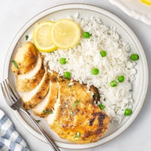 sliced Italian lemon chicken breast with white rice and peas