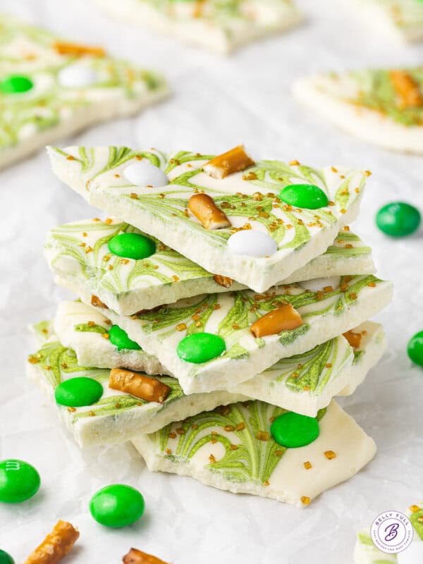 Stack of St. Patrick's Day white chocolate bark with pretzels and green M&Ms