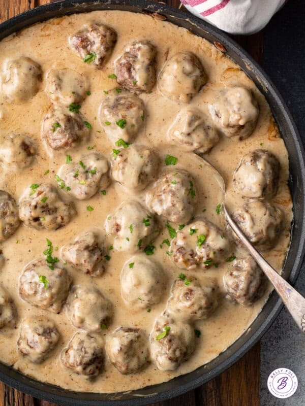 Overhead view of a skillet of gravy smothered Swedish meatballs