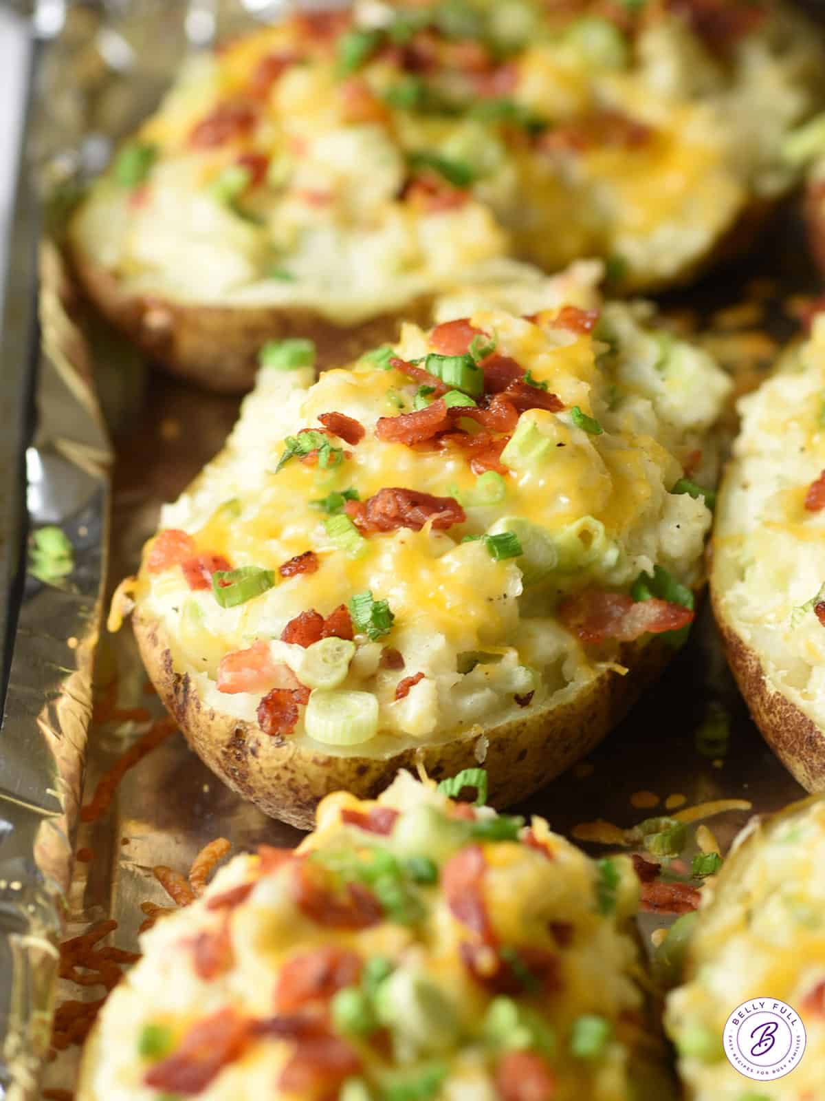 baked potatoes with cheese, bacon, and scallions