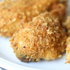 close up cornflake coated baked chicken drumstick