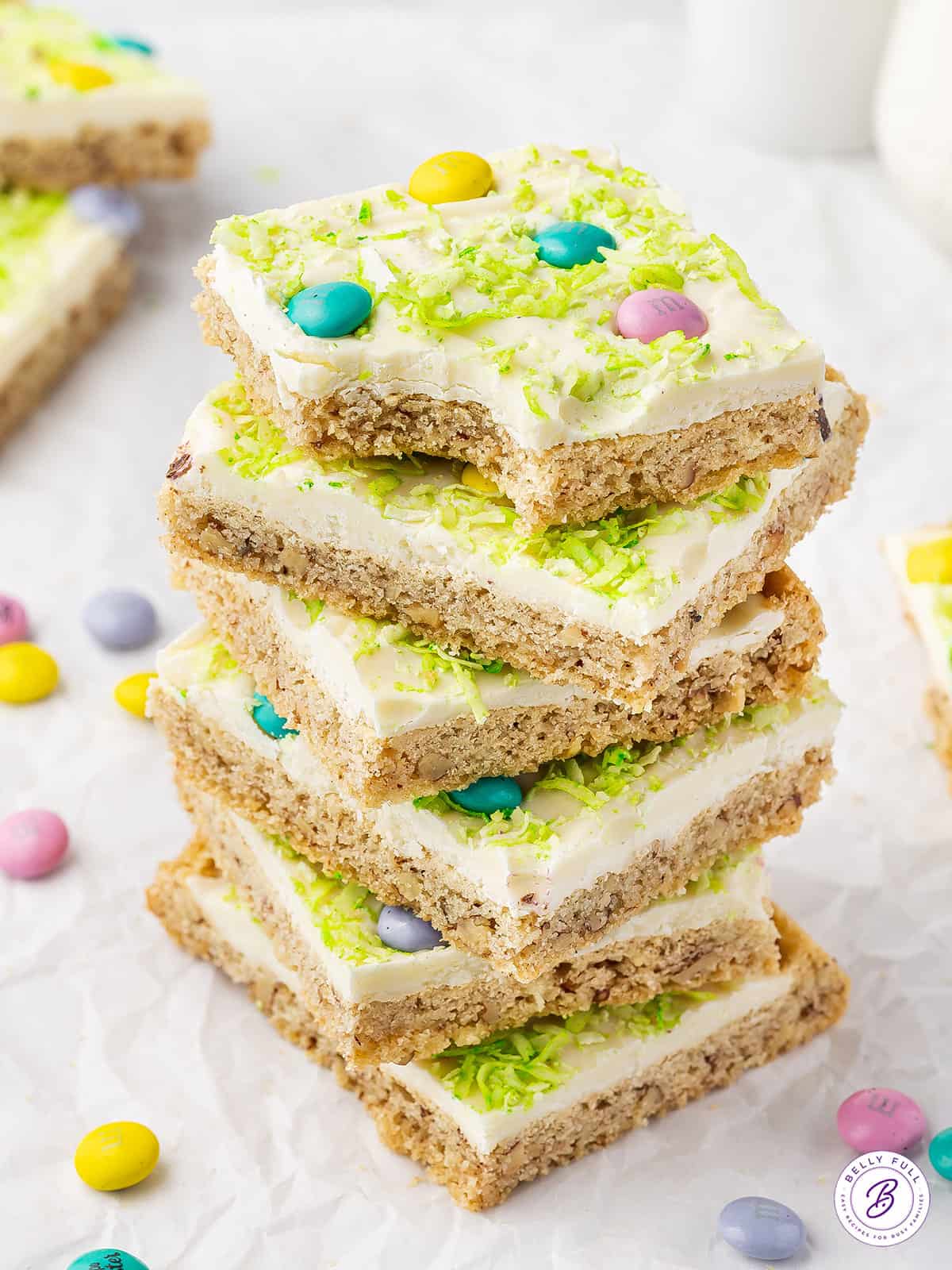 Stack of 6 frosted sugar cookie bars with pastel M&Ms