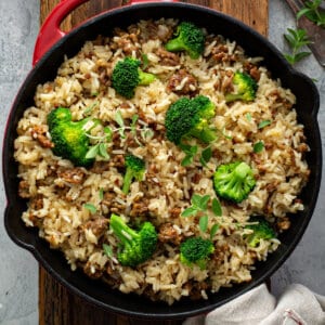 overhead skillet of cooked sausage rice and broccoli