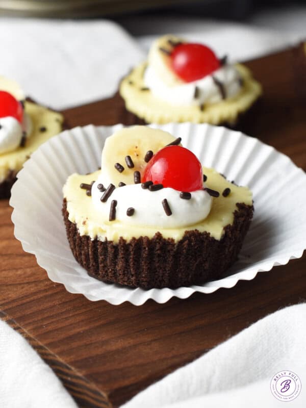 mini banana split cheesecake with paper liner peeled back