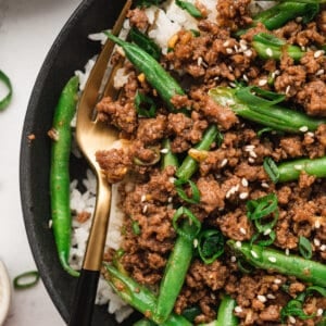 Korean ground beef and green beans over white rice in bowl