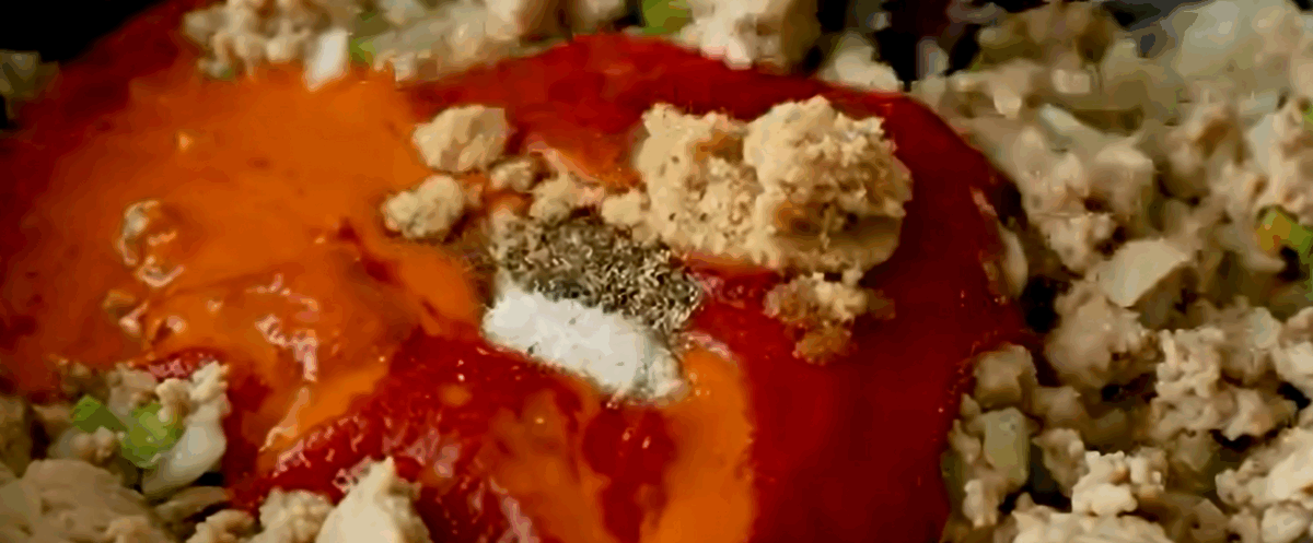 Adding the sauce ingredients to the ground chicken and vegetables.