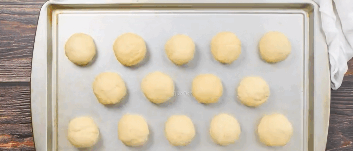 14 dough balls on a baking sheet.