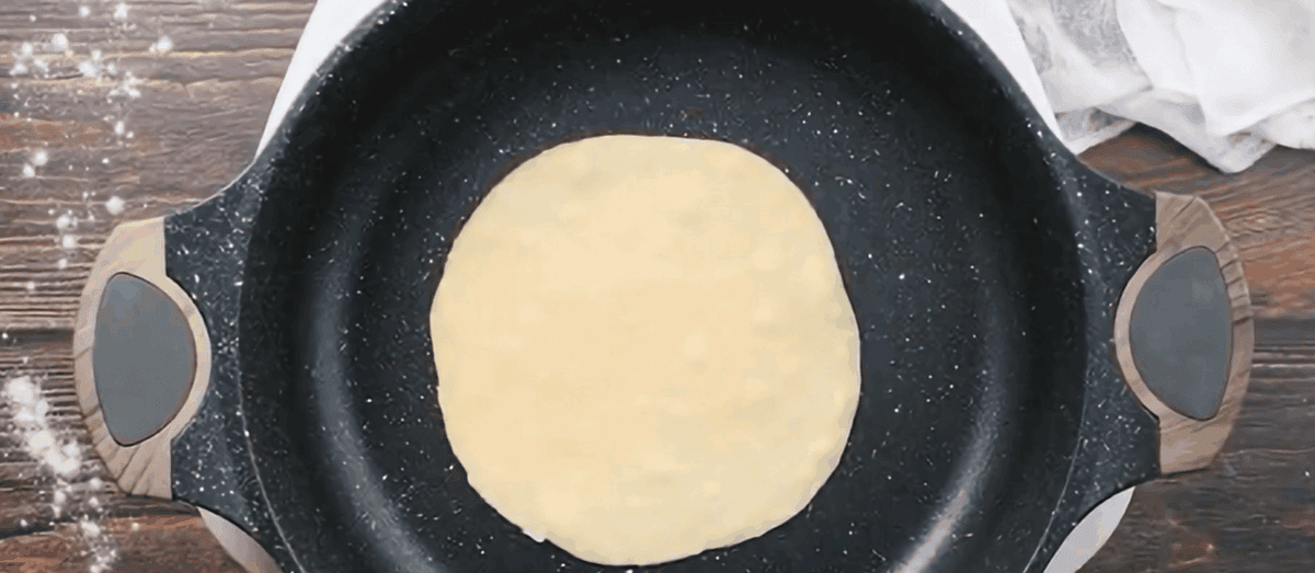 Cooking a tortilla in a skillet.