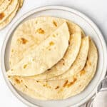 Folded flour tortillas on a plate