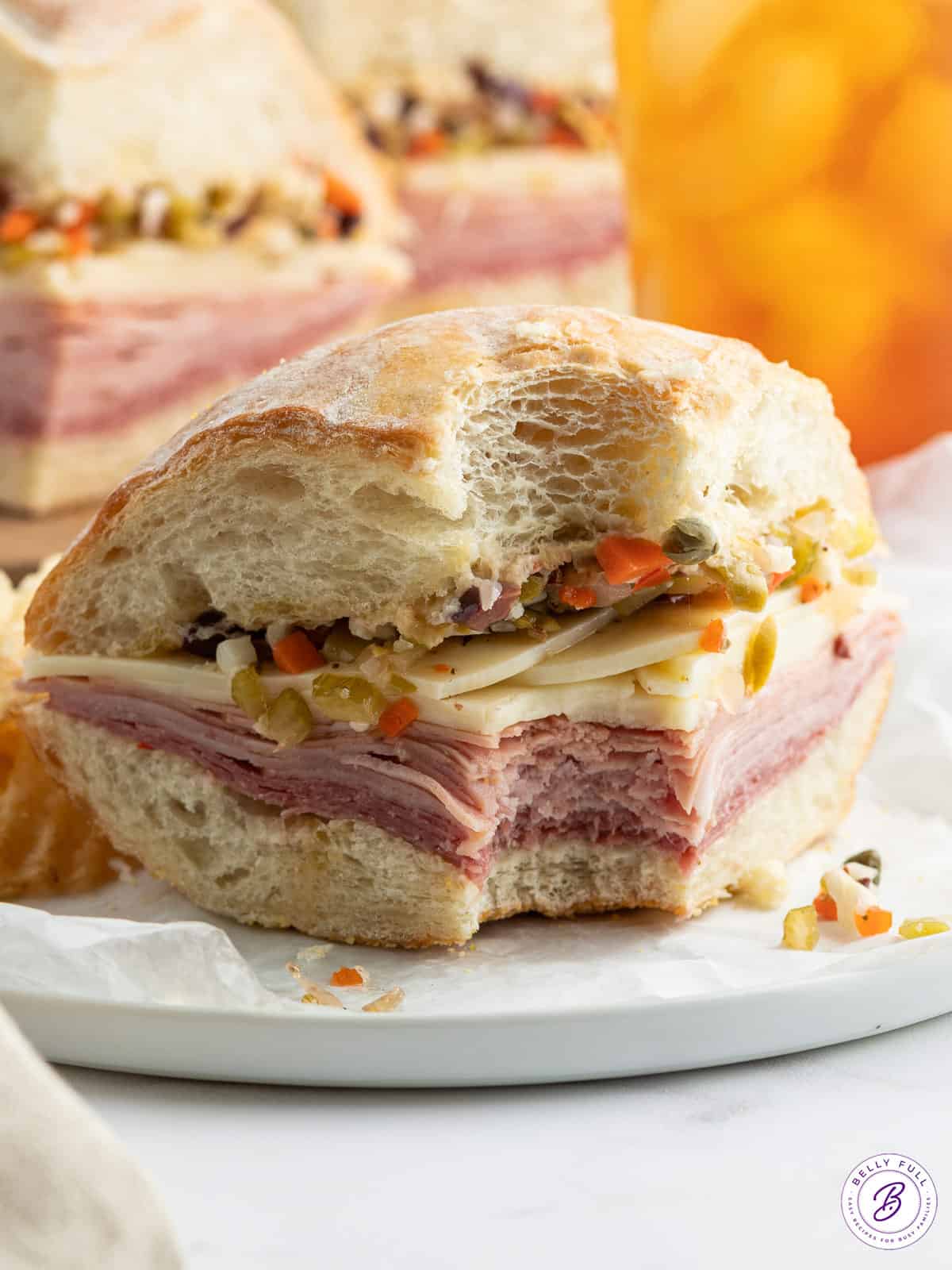 front view of a Muffuletta sandwich with bite taken