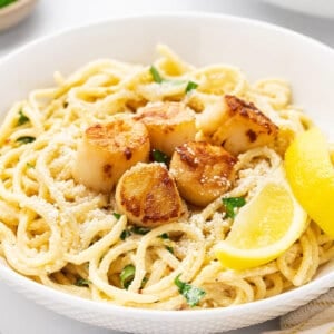 Seared scallop piccata with spaghetti in a bowl