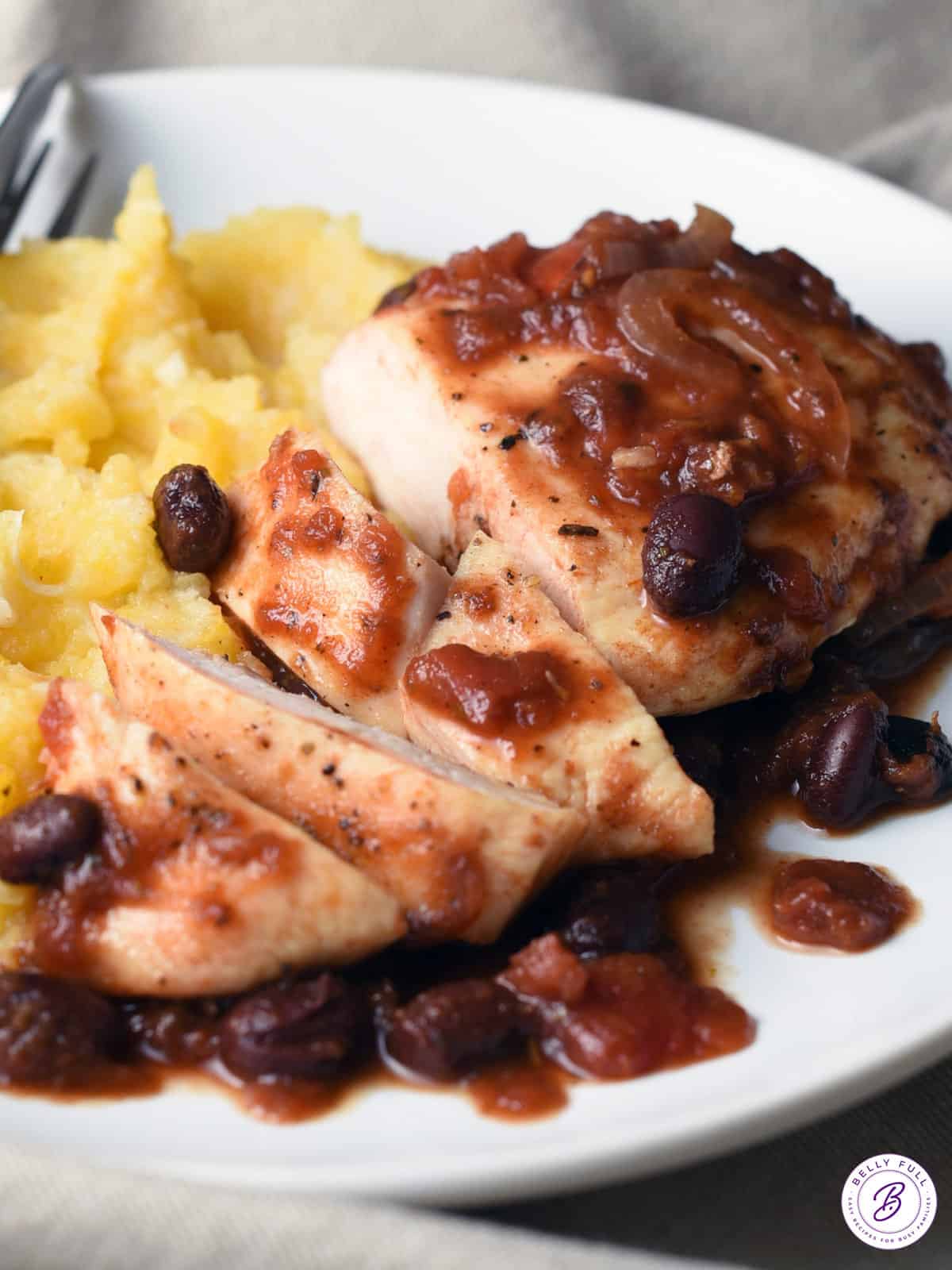 sliced chicken breast with black beans and tomato balsamic sauce