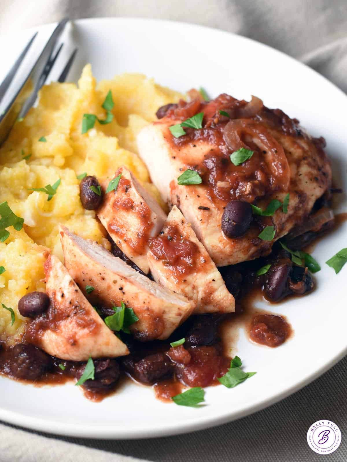 sliced chicken breast with black beans and tomato sauce