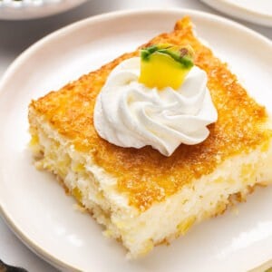 square slice of pineapple cake with piped whipped cream