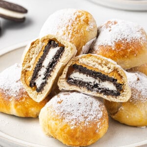 A pile of air fryer fried Oreos, with one cut in half to show the inside