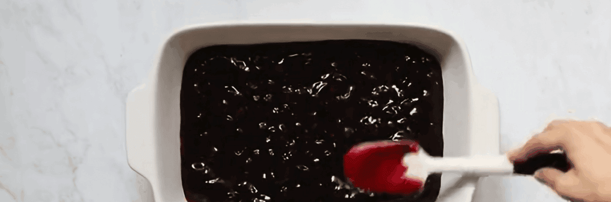 Spreading blueberry filling into pan.