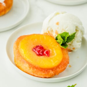 upside down pineapple cake on plate with vanilla ice cream