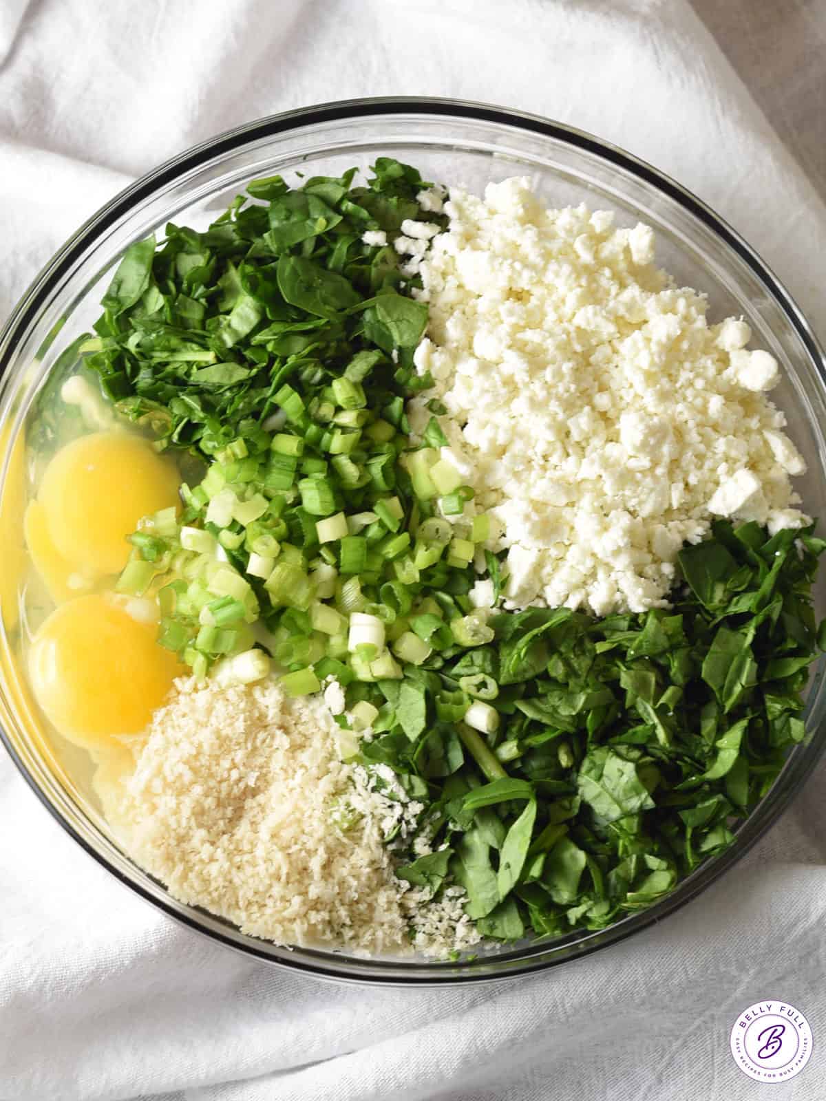 separated ingredients for spanakopita in bowl