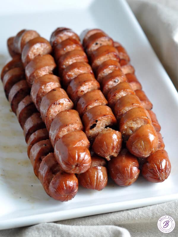 stack of spiral grilled hot dogs on serving platter