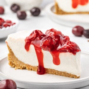A slice of no bake cherry cheesecake on a plate
