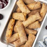 Overhead view of cherry cheesecake egg rolls in a baking dish