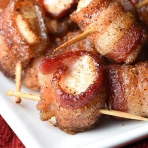 close up chicken piece wrapped in crispy bacon