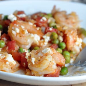 cooked shrimp with tomatoes, peas, and feta cheese