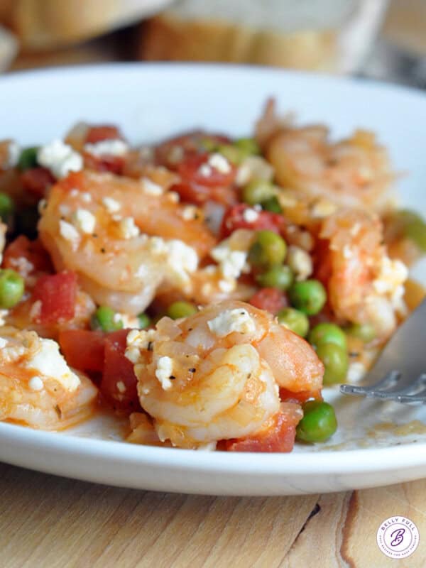 cooked shrimp with tomatoes, peas, and feta cheese