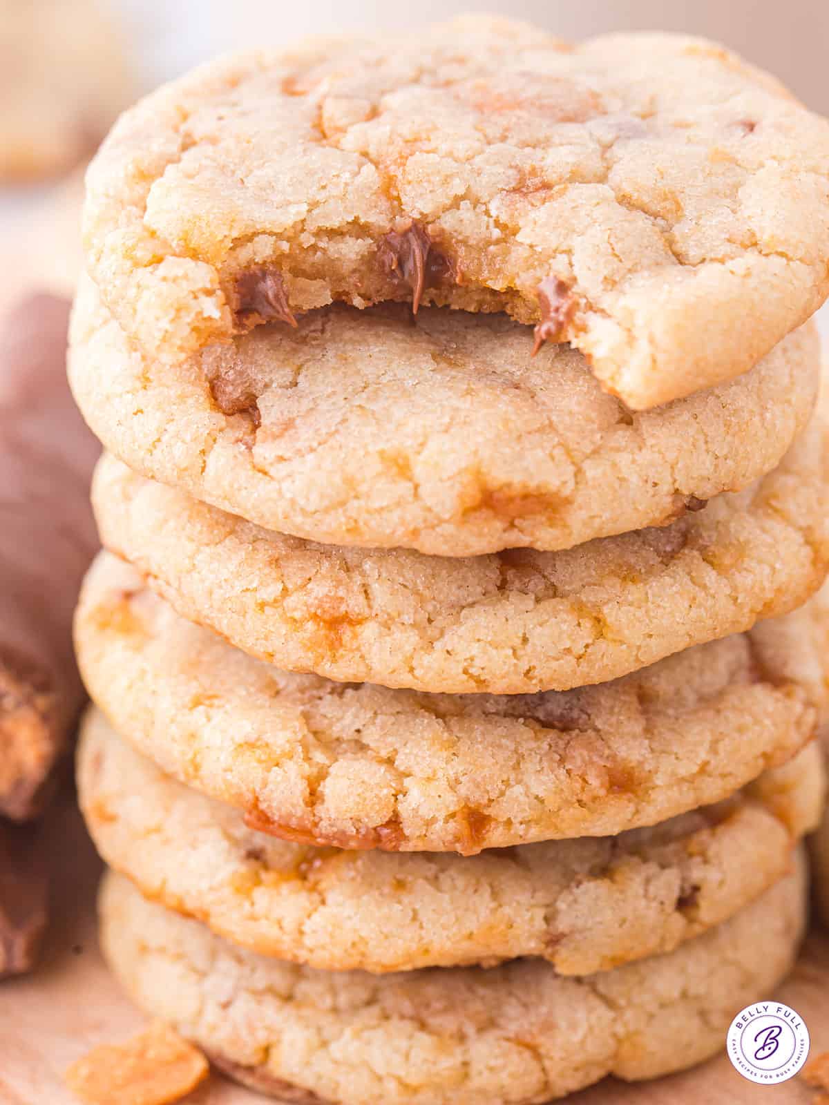 A stack of butterfinger cookies, one with a bite missing