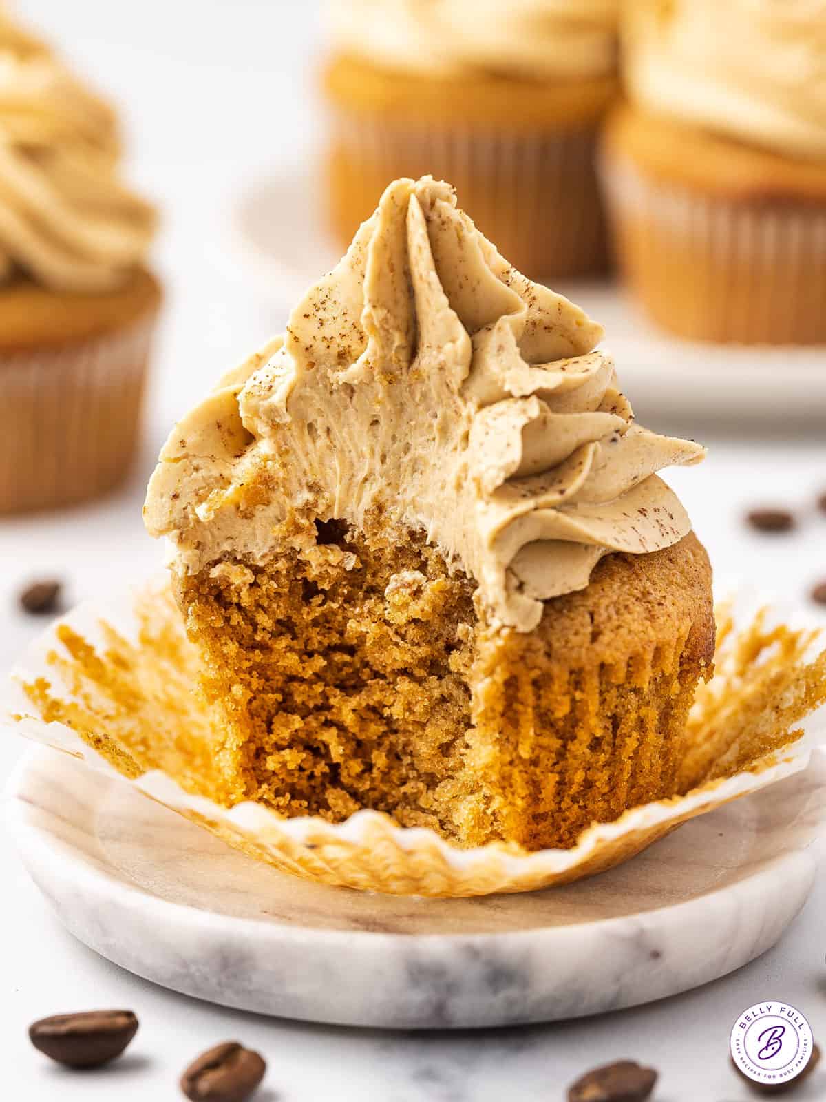 A coffee cupcake with a bite missing